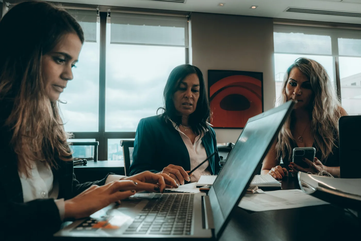 Marketing team reviewing social media analytics and content calendar on screens