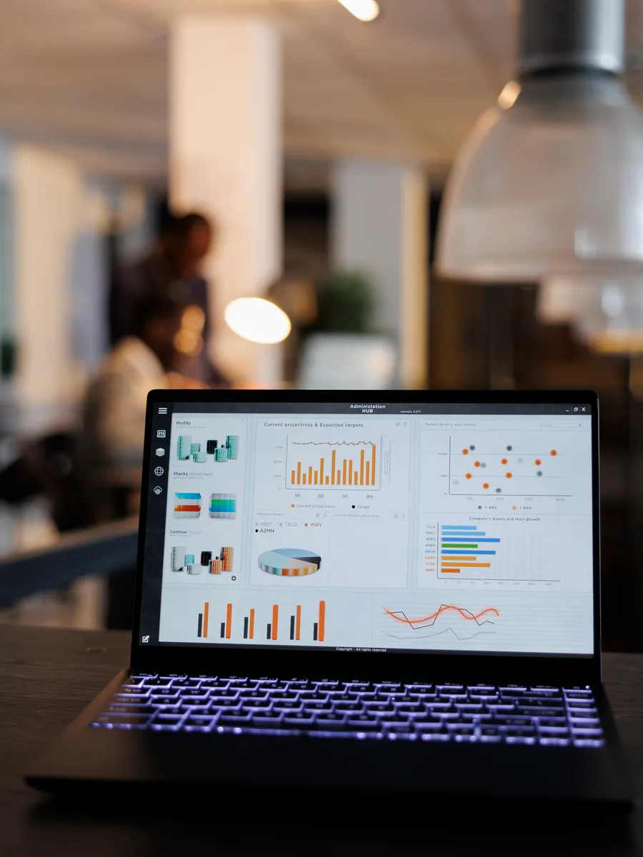 Marketing team reviewing ad performance metrics and A/B test results on laptops