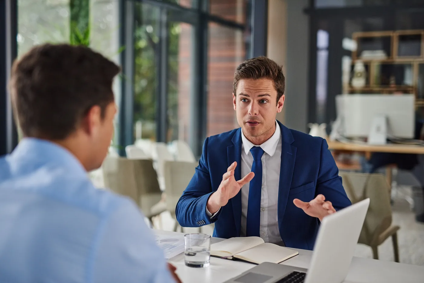 Attorney reviewing email marketing analytics on a laptop in a law office