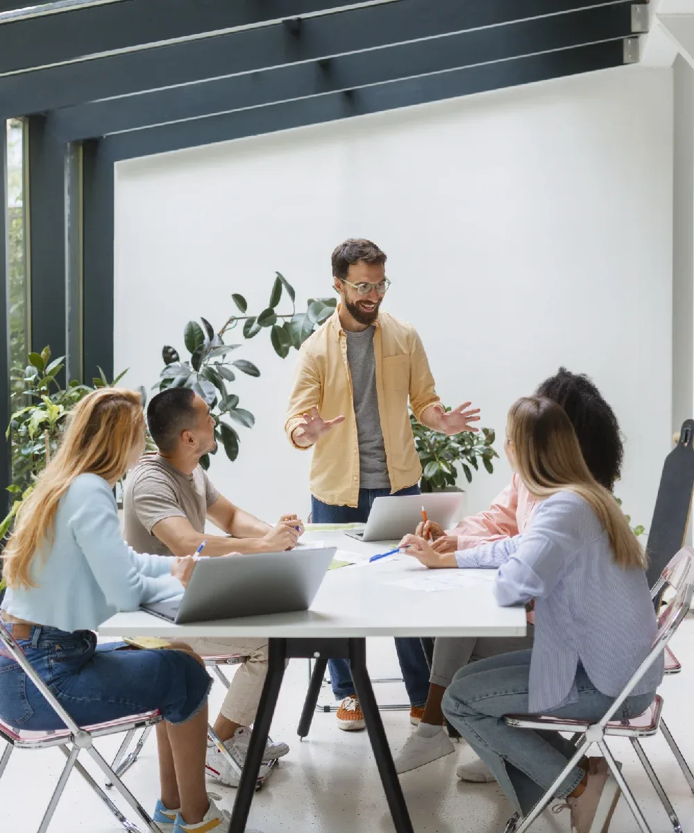 Vigorant marketing team reviewing a custom business website on multiple screens
