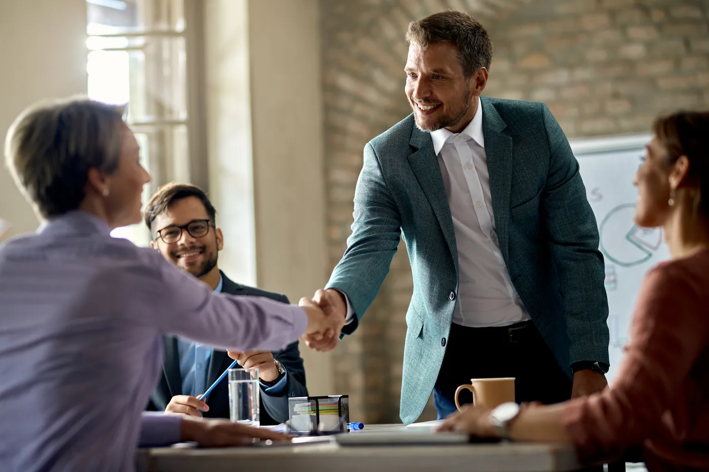 Vigorant healthcare marketing team reviewing a custom chiropractic website on multiple screens