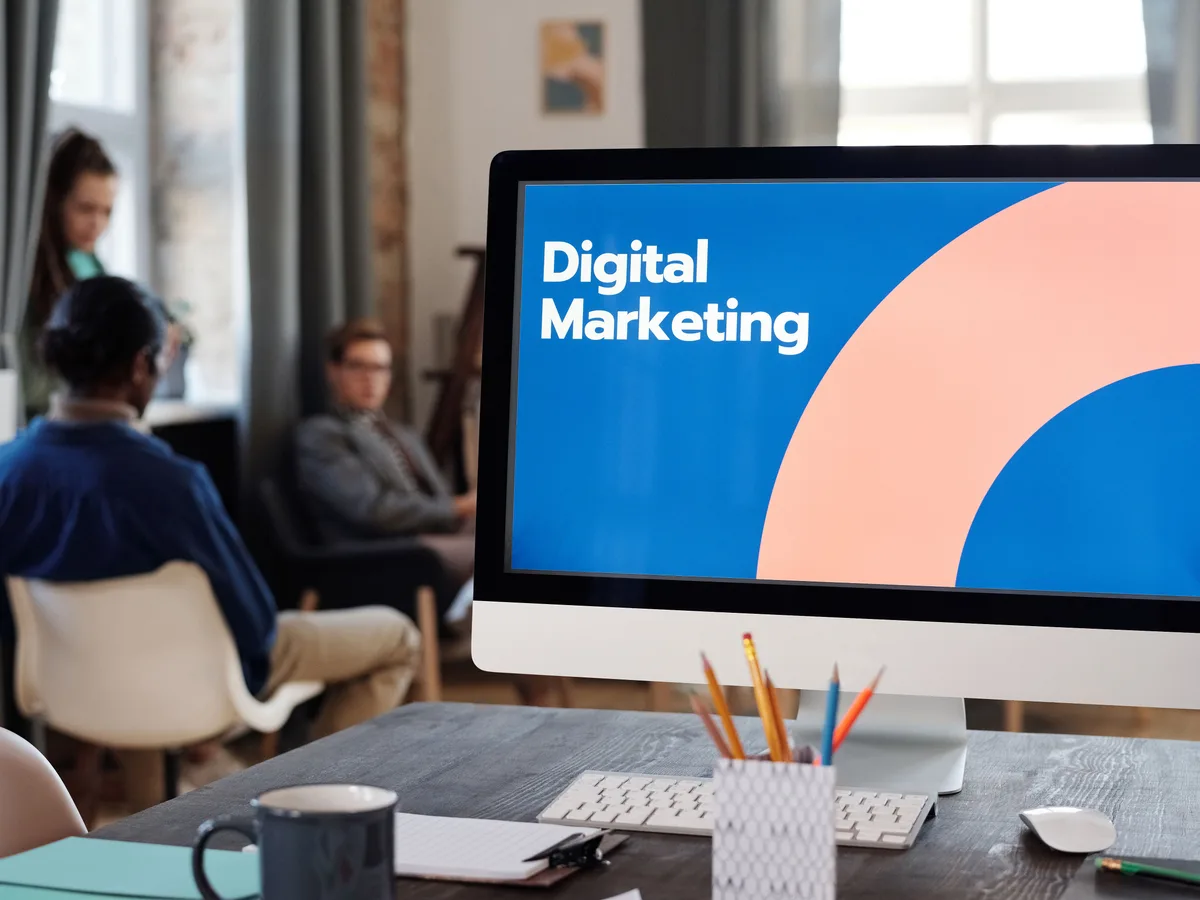 Marketing analyst configuring a Google Ads campaign and reviewing keyword data on a screen