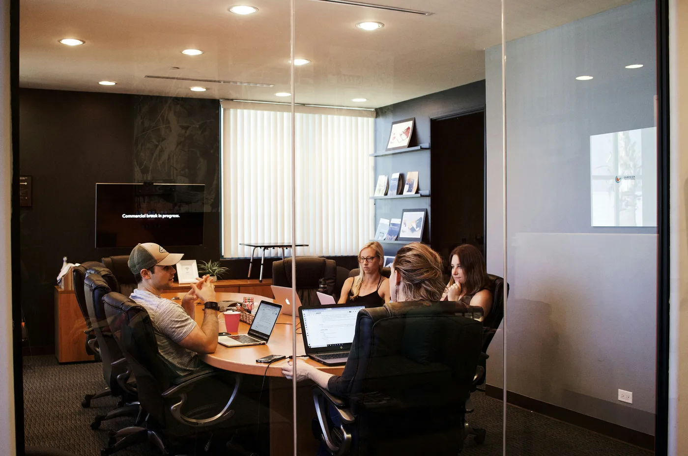 Marketing team reviewing Google Ads campaign performance data and planning optimisation actions