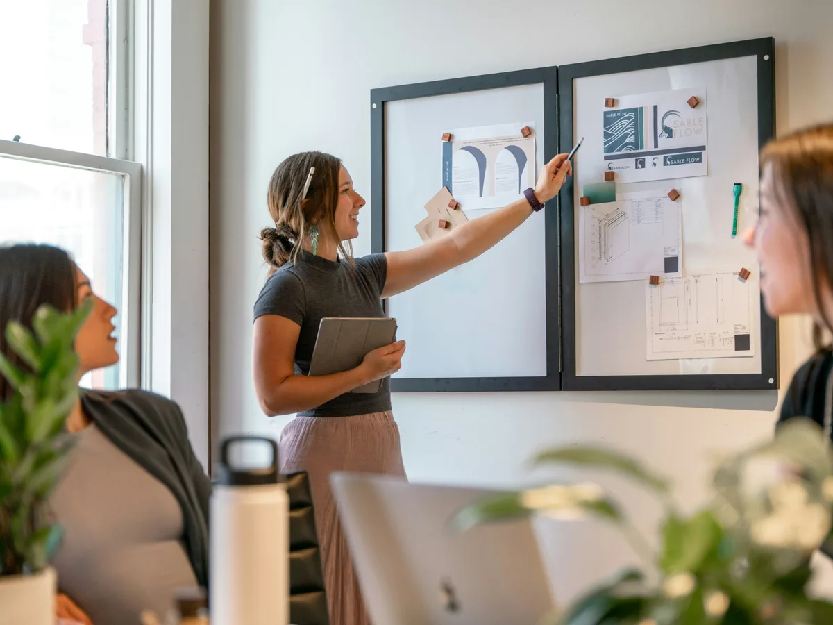 Designer reviewing a healthcare website layout and navigation flow on a screen