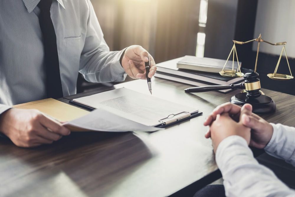 Law firm consultation — attorneys discussing legal strategy at a conference table