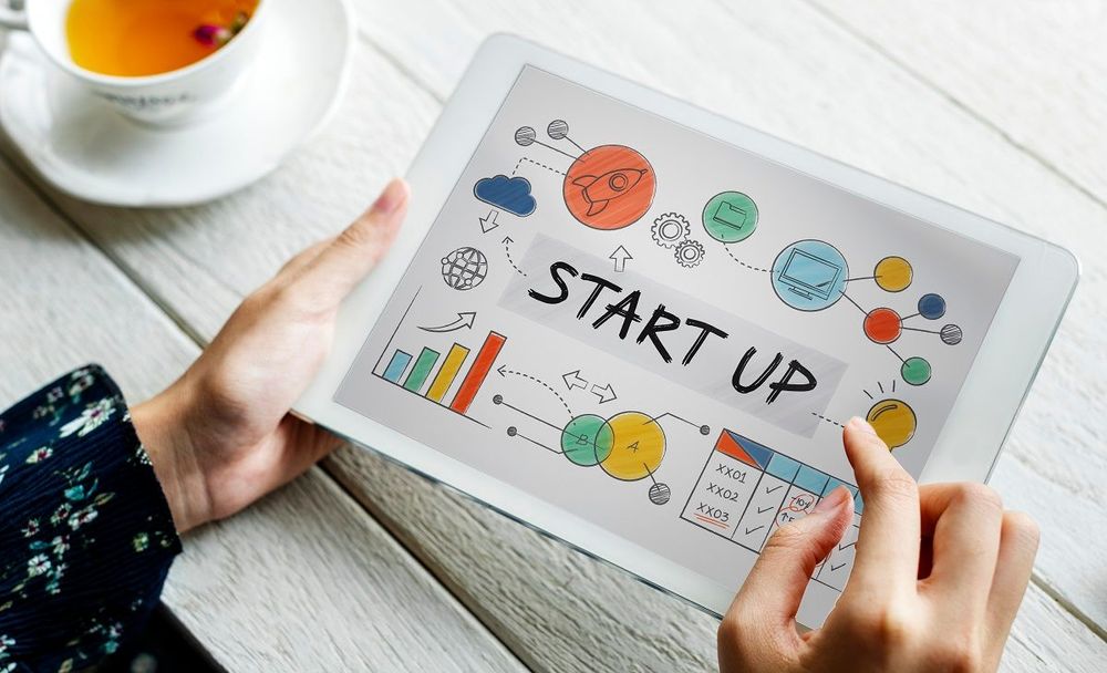 Startup founder using a tablet to manage digital marketing campaigns