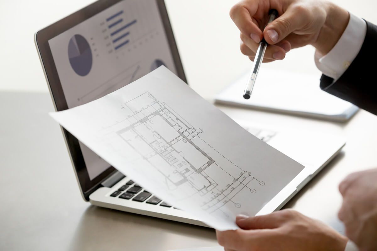 male-hand-holding-project-plan-statistics-screen-close-up.jpg